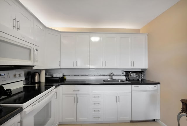 kitchen featuring white cabinets, white appliances, and sink