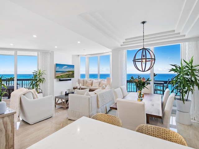 living room featuring light tile patterned floors, an inviting chandelier, and floor to ceiling windows