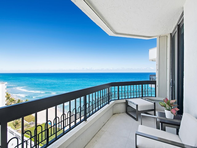 balcony with a view of the beach and a water view