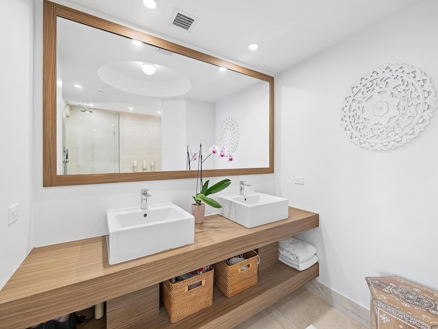 bathroom featuring vanity, tile patterned floors, and a shower with shower door