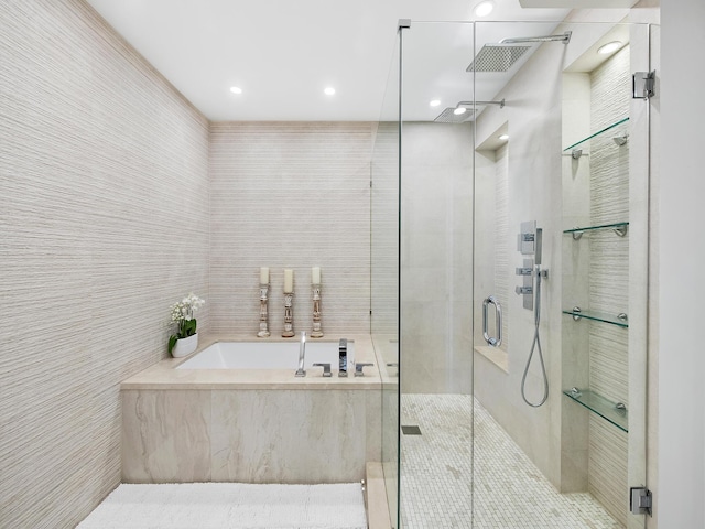 bathroom with tile walls and shower with separate bathtub