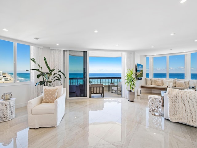 living room with a water view and a view of the beach