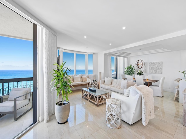 living room with floor to ceiling windows and a water view