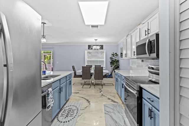 kitchen with hanging light fixtures, stainless steel appliances, blue cabinets, white cabinets, and sink