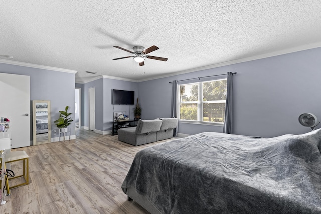 bedroom with a textured ceiling, ceiling fan, crown molding, and light wood-type flooring