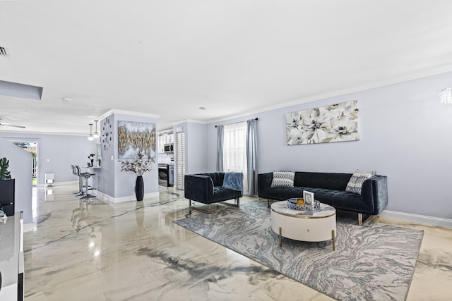 living room with ceiling fan and crown molding