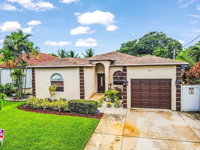 view of front of house featuring a garage and a front yard