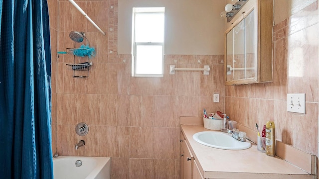 bathroom featuring vanity, shower / bath combination with curtain, and tile walls