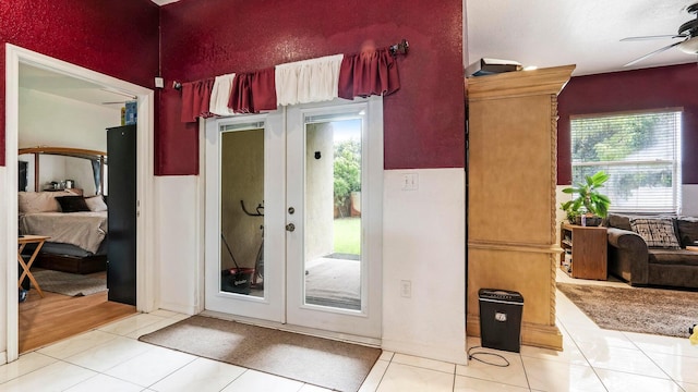 doorway to outside with ceiling fan, french doors, and light tile patterned flooring