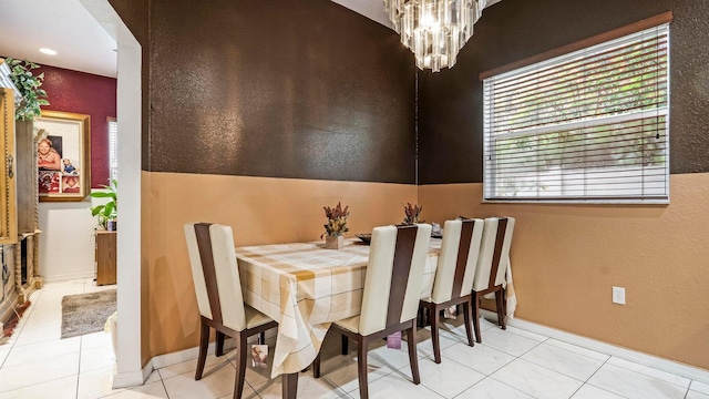 dining area featuring light tile patterned floors, lofted ceiling, and a notable chandelier