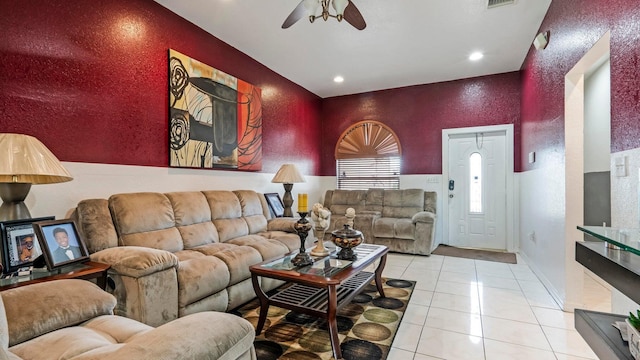 tiled living room featuring ceiling fan