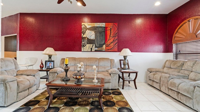 tiled living room with ceiling fan