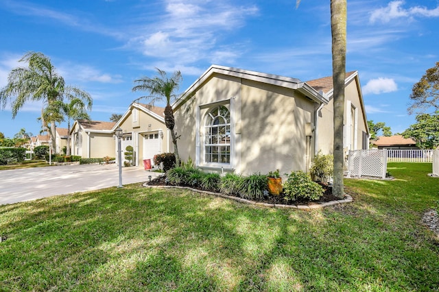 view of front of home with a front yard and a garage