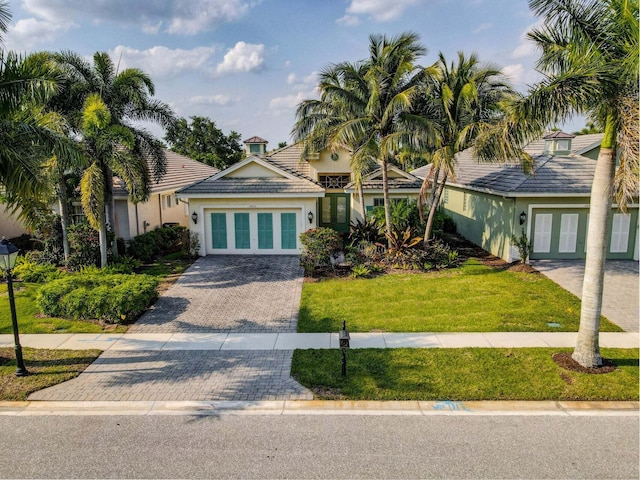 view of front of home with french doors and a front lawn