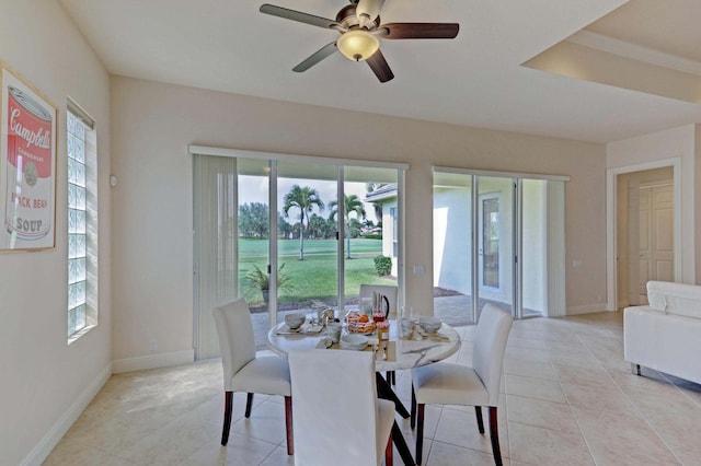 tiled dining room featuring ceiling fan