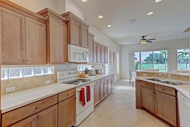 kitchen with tasteful backsplash, white appliances, ceiling fan, sink, and light tile patterned floors