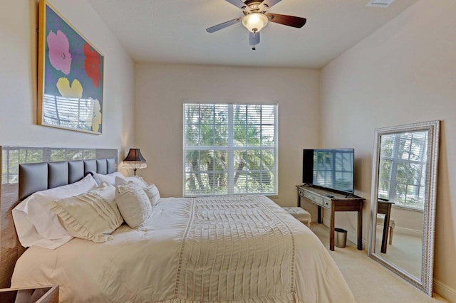 bedroom with ceiling fan and light carpet