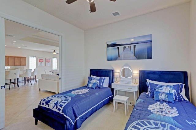 tiled bedroom featuring ceiling fan