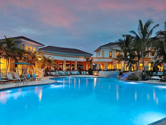 pool at dusk with pool water feature