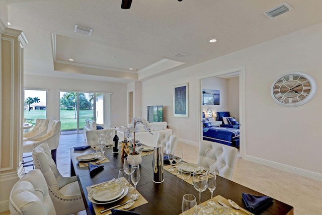 tiled dining room featuring a tray ceiling