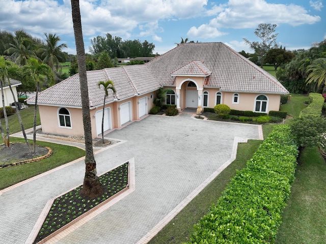 mediterranean / spanish house featuring a garage