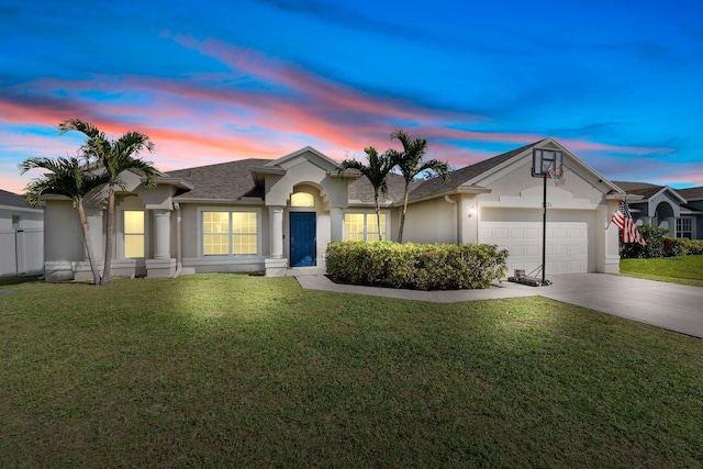 ranch-style home featuring a lawn and a garage