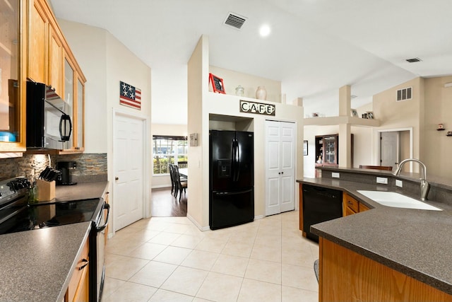 kitchen with light tile patterned flooring, tasteful backsplash, lofted ceiling, sink, and black appliances