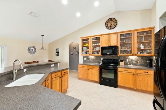 kitchen featuring vaulted ceiling, pendant lighting, sink, backsplash, and black appliances