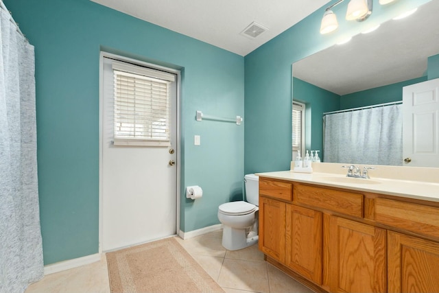 bathroom with vanity, toilet, and tile patterned flooring