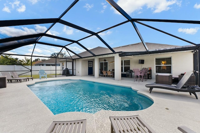 view of swimming pool featuring a lanai, a patio, and ceiling fan