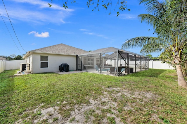 rear view of house with a pool, a patio, a lanai, and a yard