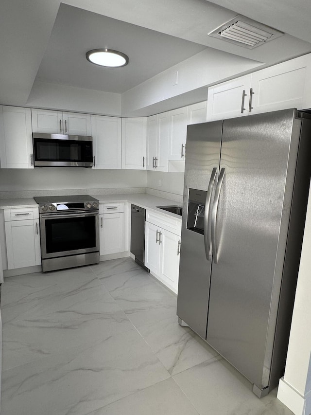 kitchen with appliances with stainless steel finishes and white cabinetry