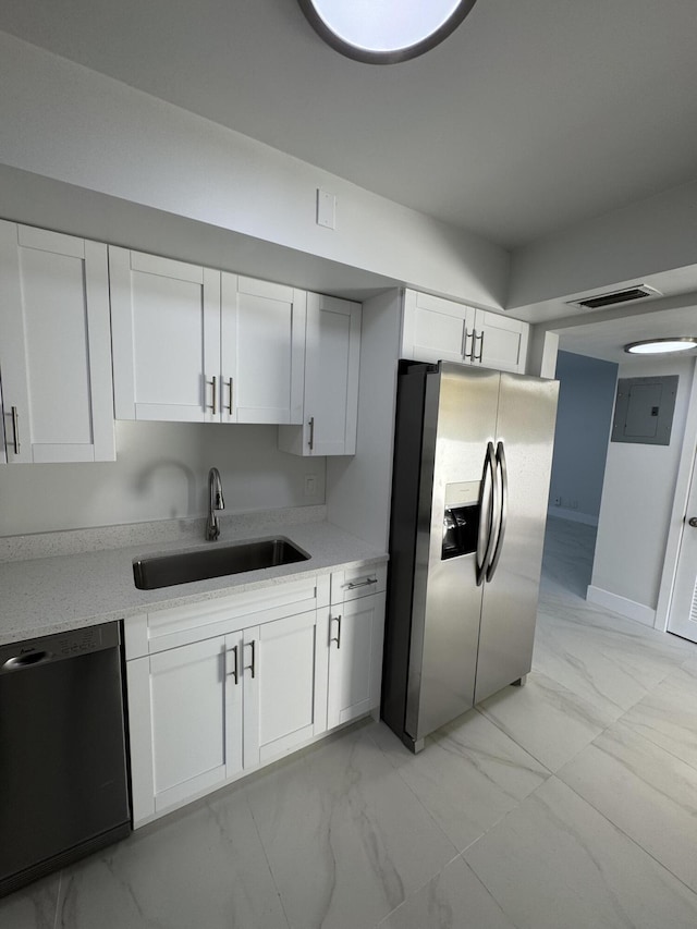 kitchen featuring sink, white cabinets, electric panel, black dishwasher, and stainless steel fridge