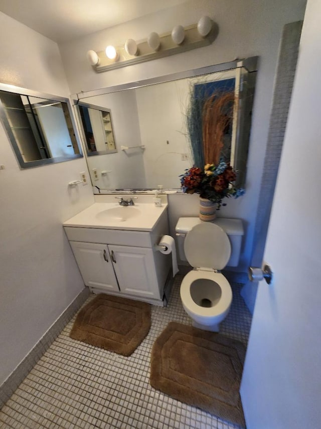 bathroom featuring tile patterned flooring, vanity, and toilet