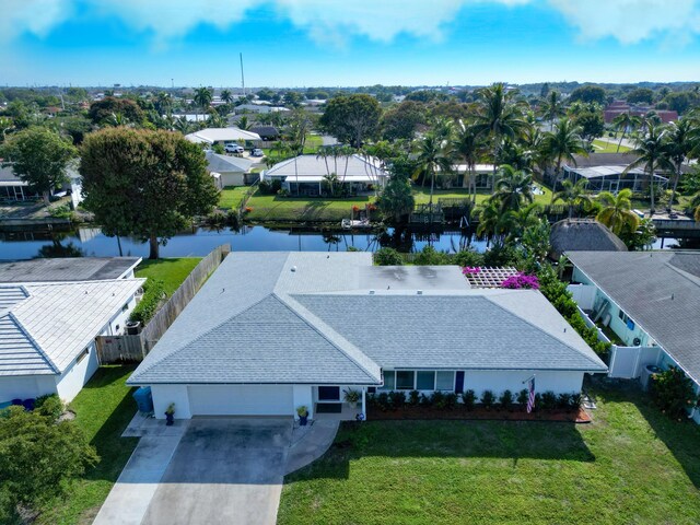 single story home featuring a garage and a front lawn