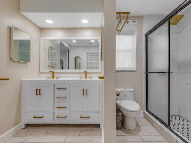 bathroom with vanity, toilet, and an enclosed shower