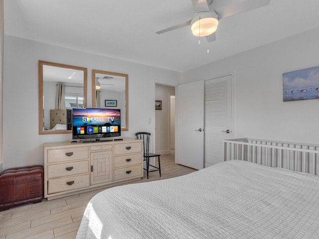 bedroom featuring light hardwood / wood-style floors, a closet, and ceiling fan