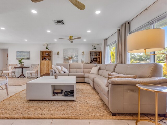 tiled living room with ceiling fan