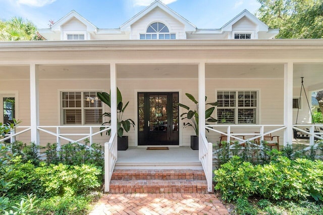 view of exterior entry featuring a porch