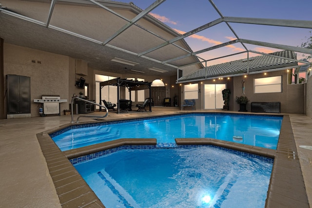 pool at dusk featuring a lanai and a patio area