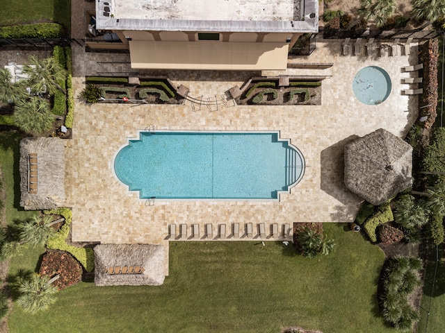 view of pool featuring a yard