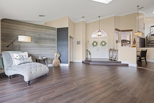 living area featuring crown molding, vaulted ceiling, dark hardwood / wood-style floors, and wood walls