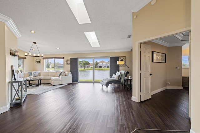 living room with a water view, ornamental molding, dark wood-type flooring, and a textured ceiling