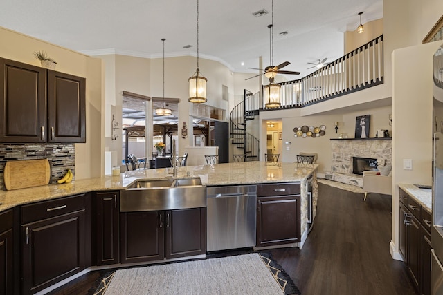 kitchen featuring dishwasher, dark brown cabinets, pendant lighting, and dark hardwood / wood-style floors