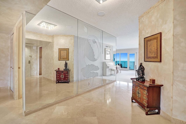 hallway with a textured ceiling