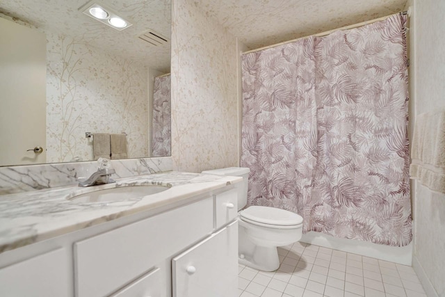 bathroom featuring vanity, tile patterned floors, and toilet