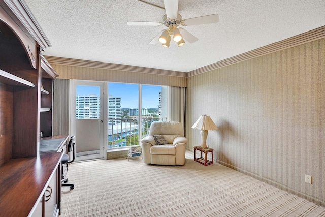 carpeted home office with ceiling fan, ornamental molding, and a textured ceiling