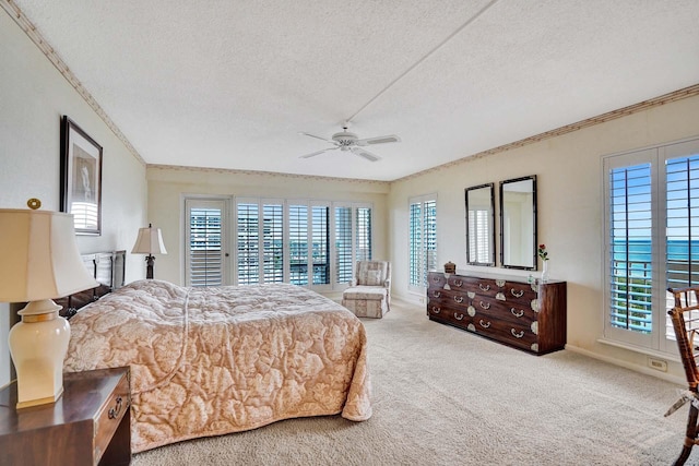 carpeted bedroom featuring a water view, ceiling fan, crown molding, and a textured ceiling