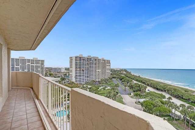 balcony with a water view and a beach view