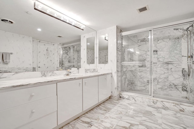 bathroom featuring vanity and a shower with shower door